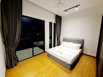 a bedroom with a bed and a large window at Beacon Executive Suites in George Town