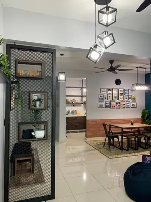 a living room with a fireplace and a table at Ammar SkyHome Ipoh in Ipoh