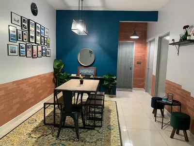 a dining room with a table and chairs at Ammar SkyHome Ipoh in Ipoh