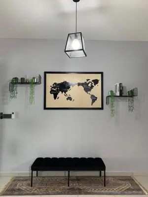 a black couch in a room with a picture on a wall at Ammar SkyHome Ipoh in Ipoh