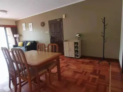 a living room with a wooden table and chairs at Cozy Home Copthorne Equatorial Hill Resort in Brinchang