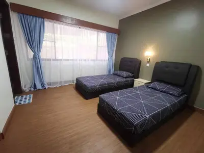 a room with two beds and a couch and a window at Cozy Home Copthorne Equatorial Hill Resort in Brinchang