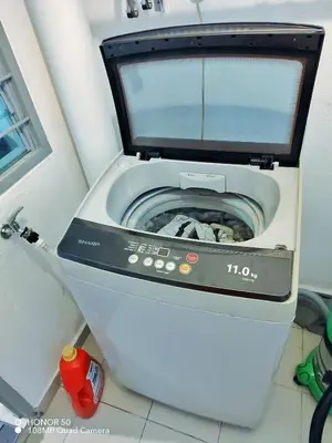 a washing machine with a monitor on top of it at Adelea Homestay MERU in Ipoh