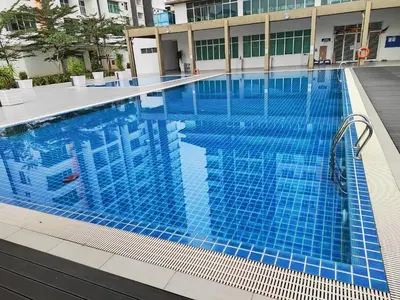 a swimming pool with blue tiles in a building at Adelea Homestay MERU in Ipoh