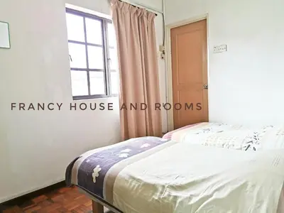 two beds in a room with a window at Chill and Traditional House in Bercham Ipoh in Ipoh