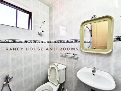 a bathroom with a toilet and a sink and a mirror at Chill and Traditional House in Bercham Ipoh in Ipoh