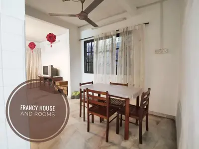 a dining room with a table and chairs at Chill and Traditional House in Bercham Ipoh in Ipoh