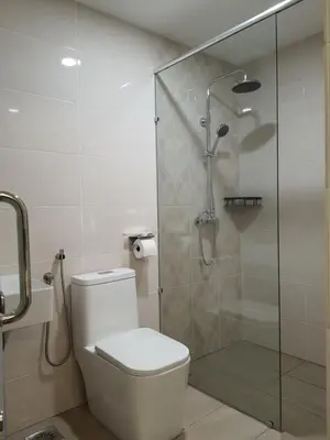 a bathroom with a toilet and a glass shower at T SQUARE HOTEL (IPOH) in Ipoh