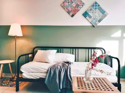 a bedroom with a bed and a table with flowers on it at Beacon Suites with Infinity Pool at Georgetown by WL in George Town