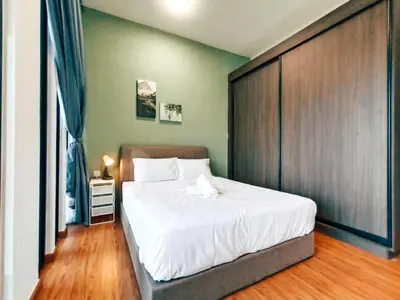 a bedroom with a large white bed with a wooden headboard at Beacon Suites with Infinity Pool at Georgetown by WL in George Town