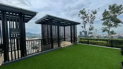 a balcony with green grass and a view of a city at Beacon Suites with Infinity Pool at Georgetown by WL in George Town