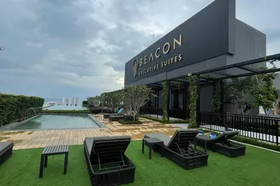 a resort with a pool and chairs and a building at Beacon Suites with Infinity Pool at Georgetown by WL in George Town