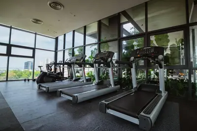 a row of treadmills in a gym with windows at Homestay at Macalister 218 Georgetown by WL in George Town