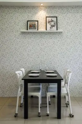 a table with white chairs and a black table with glasses at Homestay at Macalister 218 Georgetown by WL in George Town