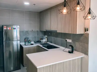 a kitchen with a refrigerator and a white counter top at Homestay at Macalister 218 Georgetown by WL in George Town