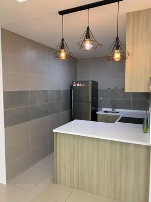 a kitchen with a white counter and a refrigerator at Homestay at Macalister 218 Georgetown by WL in George Town