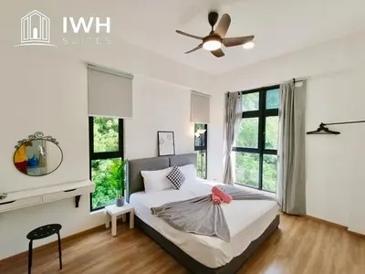 a bedroom with a bed with a ceiling fan at The Cove Premium Suites 7-13pax by IWH Suites in Ipoh