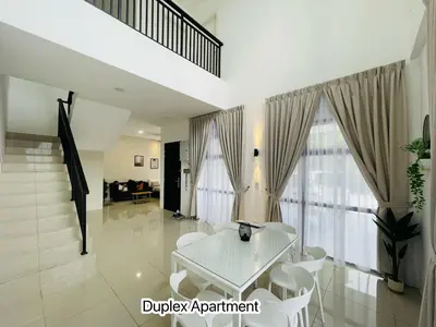 a white table and chairs in a living room at The Cove Premium Suites 7-13pax by IWH Suites in Ipoh