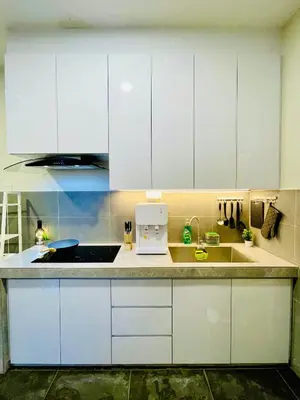 a kitchen with white cabinets and a sink at The Cove Premium Suites 7-13pax by IWH Suites in Ipoh