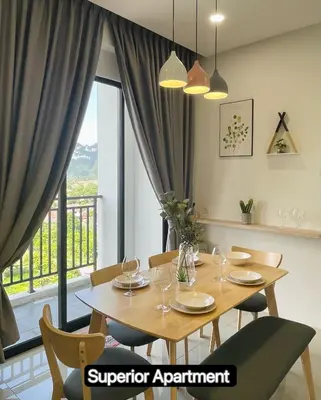 a dining room with a table and chairs and a window at The Cove Premium Suites 7-13pax by IWH Suites in Ipoh