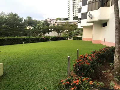 a large lawn in front of a building at Beach Resort Home Stay SRI SAYANG APARTMENT BATU FERRINGHI 2BEDROOM in Batu Ferringhi