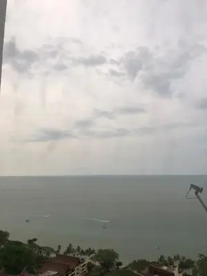 a view of the ocean on a cloudy day at Beach Resort Home Stay SRI SAYANG APARTMENT BATU FERRINGHI 2BEDROOM in Batu Ferringhi