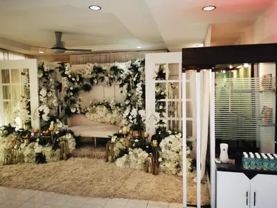a room with a floral wall with a couch and flowers at Prairie Villa Homestay in Lumut