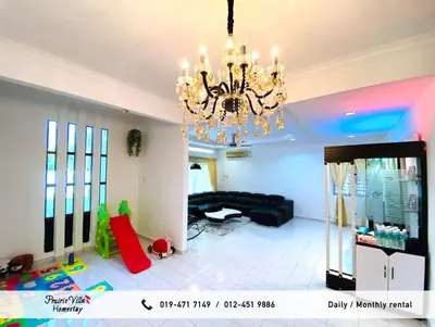 a living room with a chandelier and a black couch at Prairie Villa Homestay in Lumut