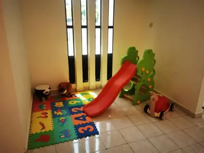a childs play room with a slide and toys at Prairie Villa Homestay in Lumut