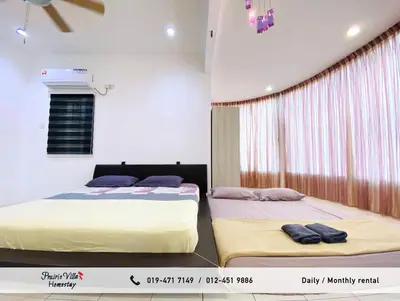 two beds sitting next to each other in a bedroom at Prairie Villa Homestay in Lumut