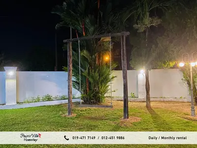 a swing in a yard at night at Prairie Villa Homestay in Lumut