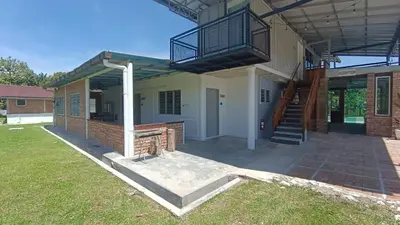 a house with a porch and a balcony on it at CofyHill Retreat in Kampong Changkat Tualang