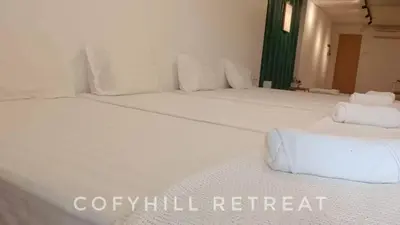 two large white beds in a room at CofyHill Retreat in Kampong Changkat Tualang