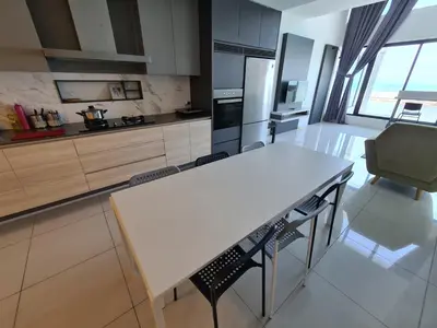 a kitchen with a white table and chairs at Sunrise Gurney Executive Premium Suite in George Town