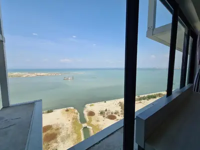 a view of the ocean from a window of a building at Sunrise Gurney Executive Premium Suite in George Town