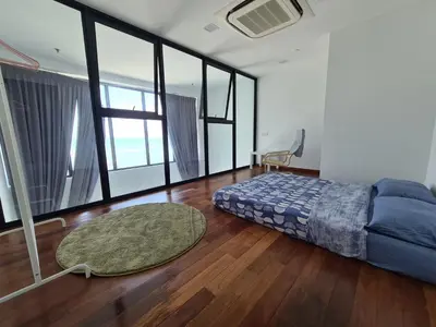 a bedroom with a bed and a large window at Sunrise Gurney Executive Premium Suite in George Town