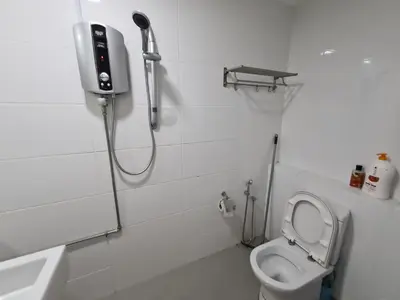 a bathroom with a shower and a toilet and a sink at Sunrise Gurney Executive Premium Suite in George Town