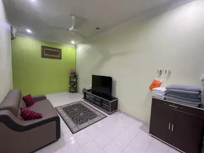 a living room with a couch and a flat screen tv at Homestay Bidor DMaju in Bidur