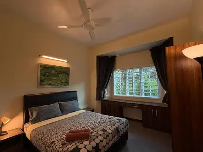 a bedroom with a bed and a window at Gerard's Place Nature Heaven Apartment in Tanah Rata