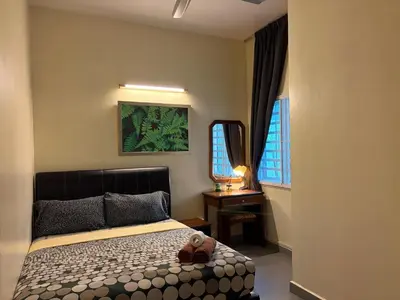 a bedroom with a bed with a teddy bear on it at Gerard's Place Nature Heaven Apartment in Tanah Rata