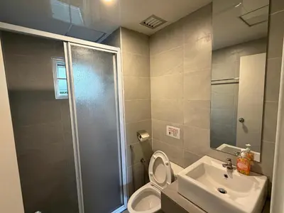 a bathroom with a shower and a toilet and a sink at Gerard's Place Nature Heaven Apartment in Tanah Rata