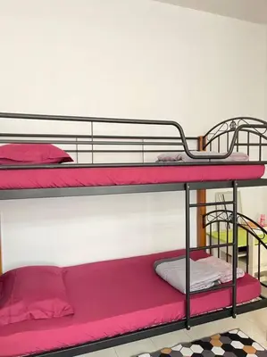 a couple of bunk beds in a room at Rose Homestay in Sitiawan
