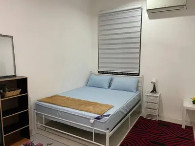 a small bedroom with a bed with a window at Rose Homestay in Sitiawan
