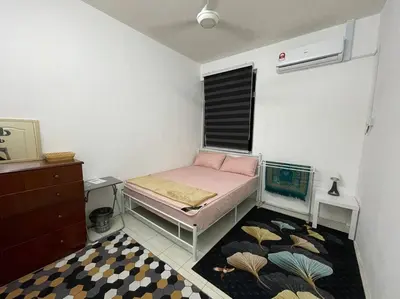 a small room with a bed and a window at Rose Homestay in Sitiawan