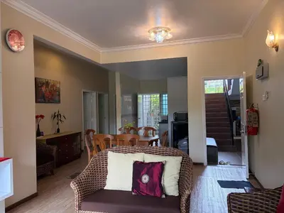 a living room with a bed and a table at Gerard's Place Nature Haven Apartment in Tanah Rata