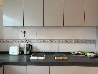 a kitchen with a counter top with a toaster and a toaster at Gerard's Place Nature Haven Apartment in Tanah Rata