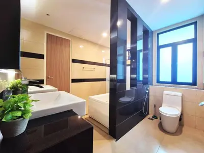 a bathroom with a sink and a toilet and a tub at FERRINGHI RESORT 5-BEDROOM with POOL, BBQ SET, WiFi, Netflix & WALK to BEACH in Batu Ferringhi