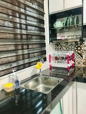 a kitchen with a sink and a counter top at Chempaka Homestay (Near to UTP UiTM Seri Iskandar) in Seri Iskandar