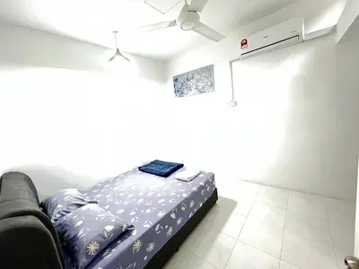 a bedroom with a bed and a ceiling fan at Chempaka Homestay (Near to UTP UiTM Seri Iskandar) in Seri Iskandar