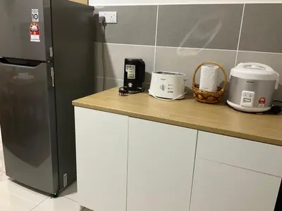 a kitchen with a counter top with a refrigerator at SCANDI HOMESTAY IPOH muslem in Ipoh